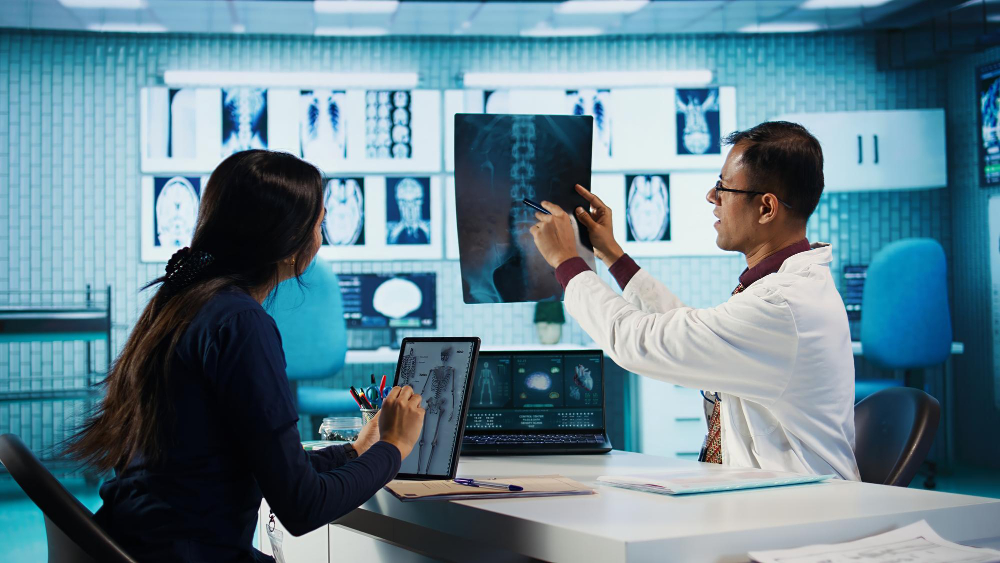 Doctors conducting a clinical assessment of a spine scan