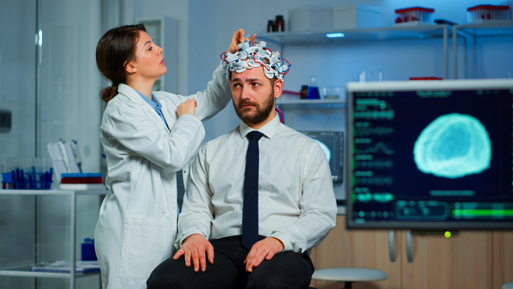 A neurologist and patient reviewing a brain scan during a neuropsychological assessment for TBI and PTSD